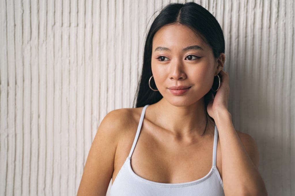 Portrait of beautiful korean woman, posing as asian model, looking away